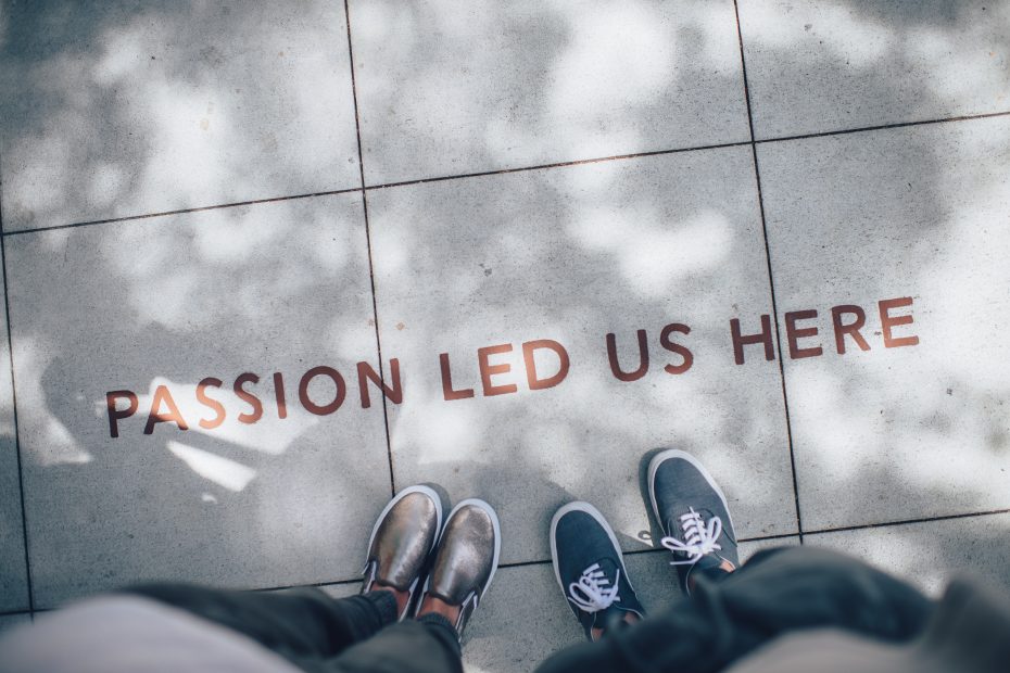A quote embedded on a footpath, read "PASSION LED US HERE"