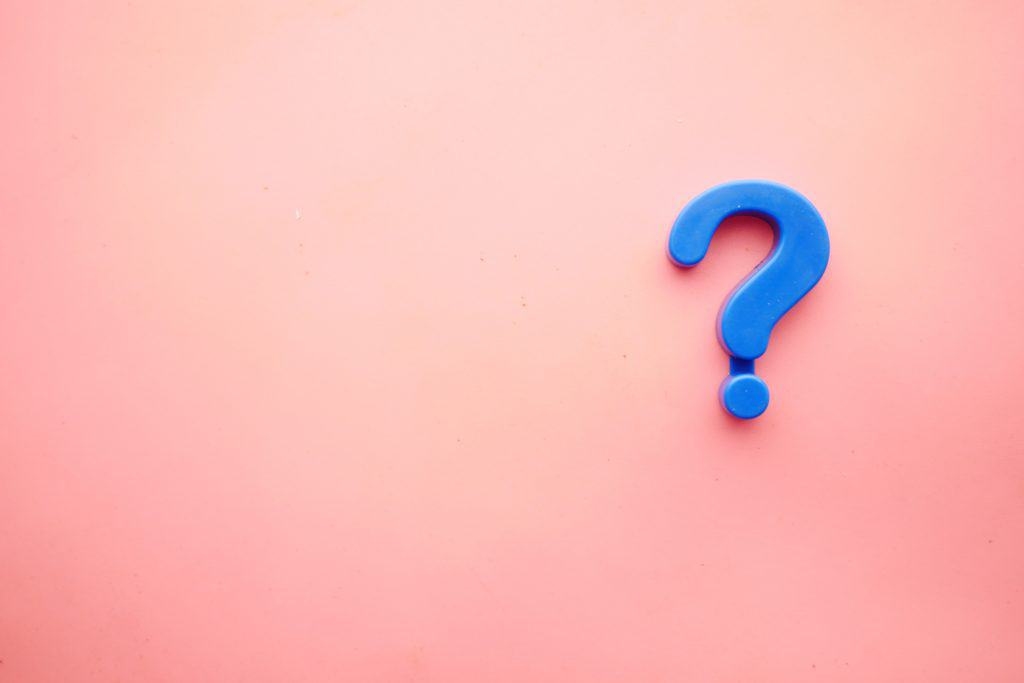 A blue question mark is on the right of a pale pink background